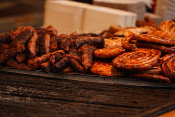 Meat and sausages on the grill. Prepared from meat with a delicious taste. Appetizing sausages. Detail photo.