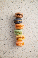 Sweet macaron dessert. Colorful macarons on kitchen table. Top view.