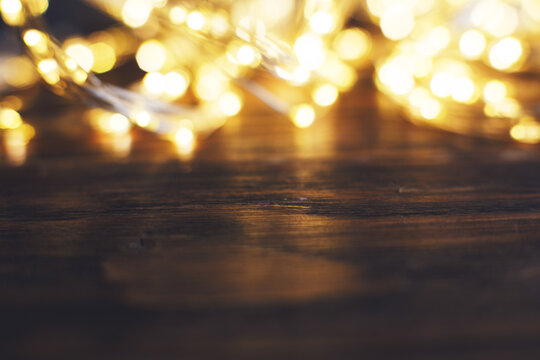 Christmas Beautifull Shiny Gold Garland On A Wooden Brown Background. Sparkle Festive Background