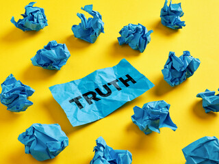 Seeking, revealing or finding the truth in tangled information. The word truth on piece of paper...