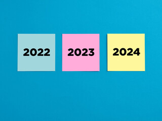 New year 2022 to 2024 on colorful note papers. Future ahead, business planning and growth idea.