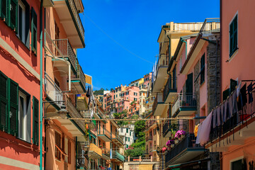 Traditional colorful houses on a narrow street in old town of Manarola in Cinque Terre on the Mediterranean Sea, Italy © SvetlanaSF