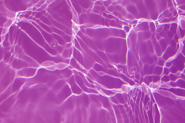Defocus blurred transparent purple colored clear calm water surface texture with splashes and bubbles. Trendy abstract nature background. Water waves in sunlight with copy space. Watercolor shine