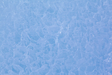 Texture of winter ice surface. Blue natural ice background