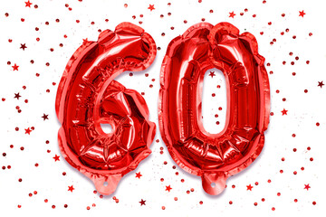The number of the balloon made of red foil, the number sixty on a white background with sequins....