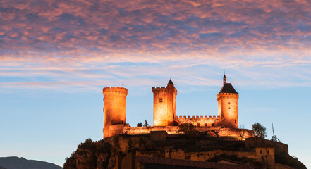 Magnificent medieval castle of Foix illuminated at night, in Ariège, Occitanie, France