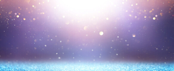 background of abstract glitter lights. gold, blue, pink and silver. de focused