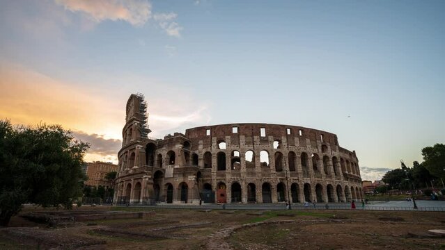 Time lapse video with moving clouds above the Colosseum at sunrise.