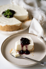 Slice of cheesecake with blueberry jam
