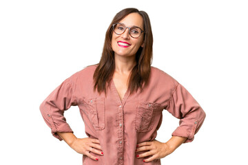Middle-aged caucasian woman over isolated background posing with arms at hip and smiling