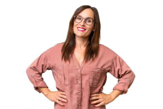 Middle-aged caucasian woman over isolated background posing with arms at hip and smiling