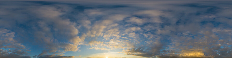 Panorama of a dark blue sunset sky with golden Cumulus clouds. Seamless hdr 360 panorama in...