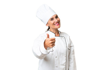 Middle-aged chef woman over isolated background with thumbs up because something good has happened