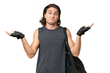 Young sport handsome man isolated on green chroma background having doubts while raising hands