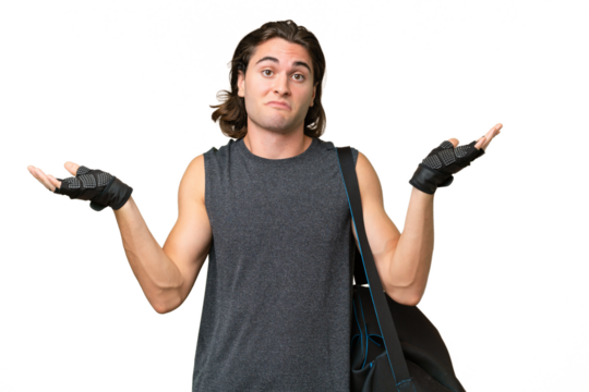 Young sport handsome man isolated on green chroma background having doubts while raising hands