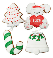 Set of gingerbread cookies decorated with icing. Christmas bell, Rabbit symbol of the year 2023, sugar cane, fir tree with a garland. Isolated on white. Bow and prediction for the New Year.