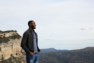 Black man contemplating nature in the mountain