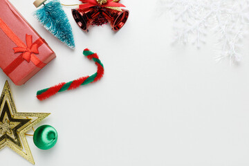Christmas composition decoration. Gifts, Bell, Christmas tree, snowflake, green ball decor on white background with right wide copy space. Christmas, winter, new year concept. Flat lay, top view.