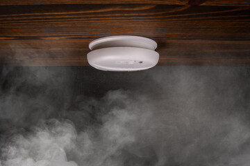 Smoke detector on the wooden ceiling. Safety and health concept