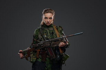 Portrait of female soldier after armageddon with self made shotgun and camouflage uniform