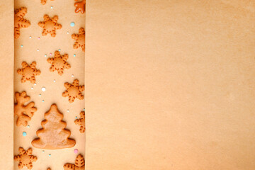 Gingerbread Christmas cakes without decorations in the form of snowflakes and Christmas trees on craft paper.Happy eco-friendly Christmas, preparation for Christmas Eve, a recipe for holiday cookies.