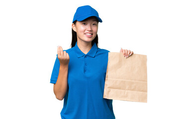 Young Asian woman taking a bag of takeaway food over isolated background making money gesture