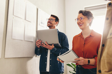 Cheerful businesspeople having a meeting in a creative workplace