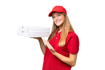Young caucasian pizza delivery woman with work uniform picking up pizza boxes over isolated...