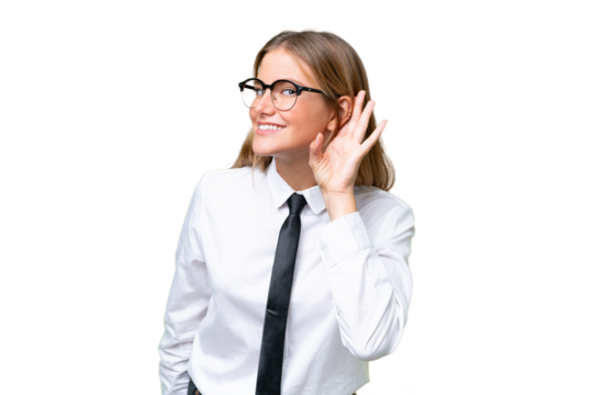 Young business caucasian woman over isolated background listening to something by putting hand on the ear