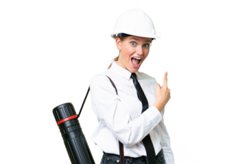 Young architect caucasian woman with helmet and holding blueprints over isolated background surprised and pointing side