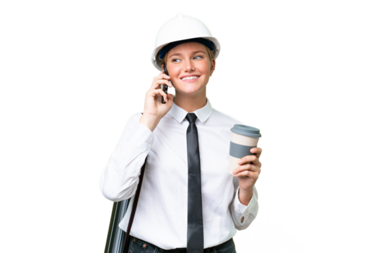 Young architect caucasian woman with helmet and holding blueprints over isolated background holding coffee to take away and a mobile