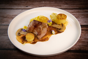 Recipe for veal, potato confit, mushroom, carrot puree, balsamic vinegar sauce, honey and veal stock. High quality photo