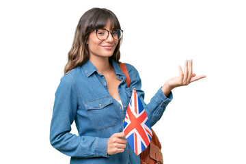 Young caucasian woman holding an United Kingdom flag over isolated background extending hands to...