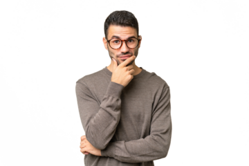 Young handsome caucasian man over isolated background having doubts