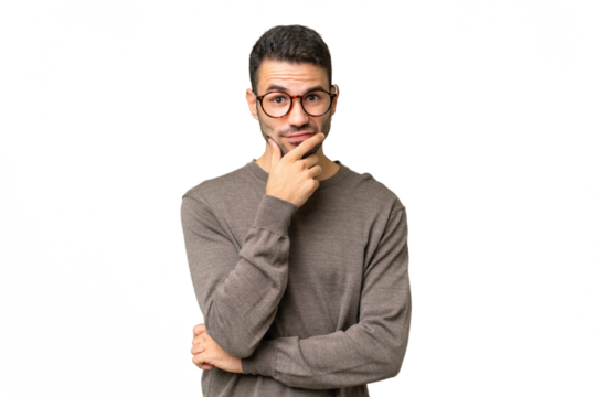 Young handsome caucasian man over isolated background having doubts