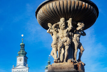 Czech Republic, South Bohemian Region, Ceske Budejovice, Samson Fountain on Premysl Otakar II Square with city hall clock tower in background
