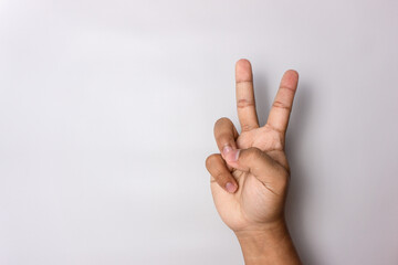 number 2 hand sign isolated on white. peace hand sign. man hand number two gesture