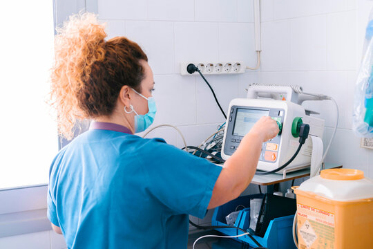 Nurse Operating Medical Equipment At Hospital