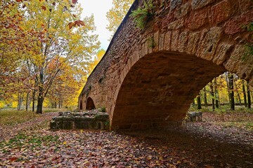 Roman bridge and autumn colours in Talamanca de Jarama, in the Madrid region of Spain