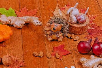 Still life with pumpkin- patison. Red viburnum berry, cranberry.Chicory root.Nuts. Autumn maple leaves.On a wooden background. meal.Thanksgiving day concept	