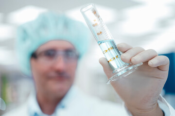Chemist holding test tube in laboratory