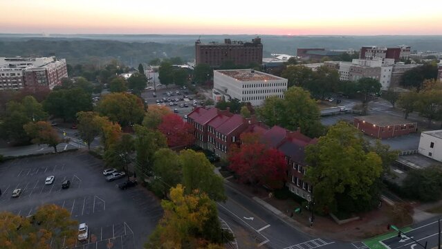 Red brick historic homes line streets in Athens Georgia during dawn sunrise. Aerial view.