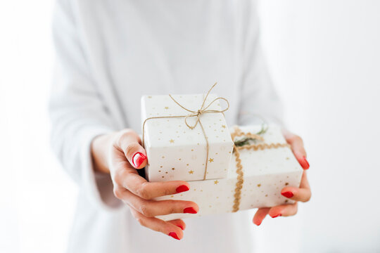 Woman Giving Christmas Presents Against White Background