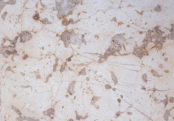 marble surface in brown and beige tones, contrasting lines in darker tones.