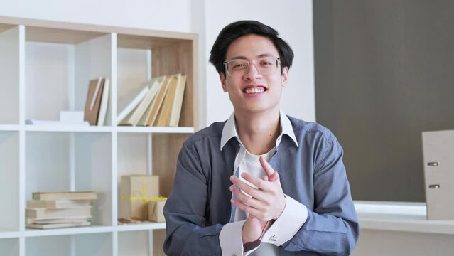 Victory congratulation. Online call. Success greeting. Proud impressed happy CEO man supporting clapping hands at home office interior.