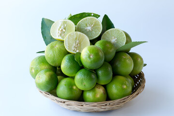 Green lemon in rattan basket for sell at market and supermarket.