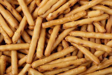 Flat lay of delicious mini pretzels sticks with copy space