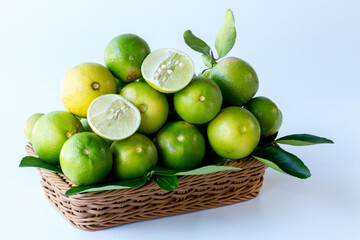 Green lemon in rattan basket for sell at market and supermarket.