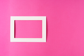 White frame on a pink pastel background, the concept of minimalism