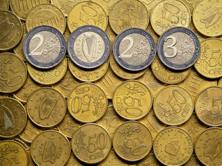Year 2023 made out of coins. Financial abstract background. White coins on yellow. Irish national...